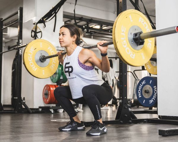 An Elite Performance client mid-squat in the downtown Vancouver studio